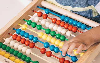 Child moving beads on a colourful Melissa and Doug branded abacus