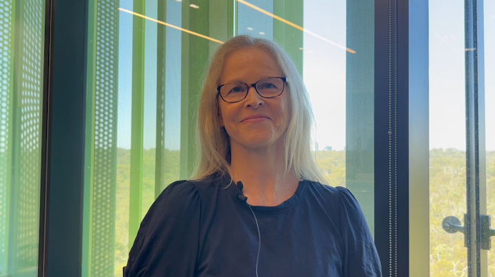 Professor Simone Pettigrew stands in front of a brightly lit window and looks directly into the camera